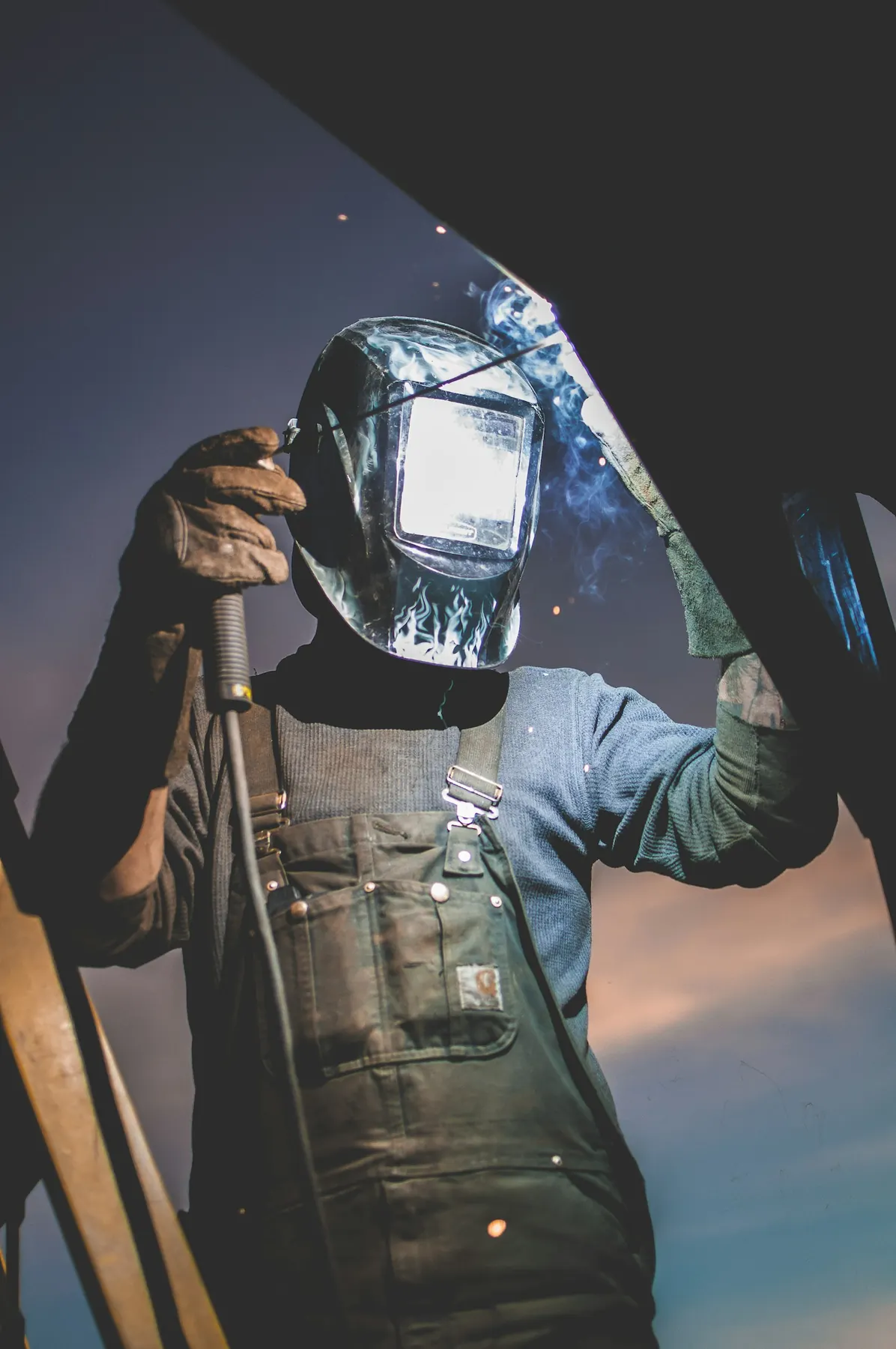 Welder at work in protective helmet